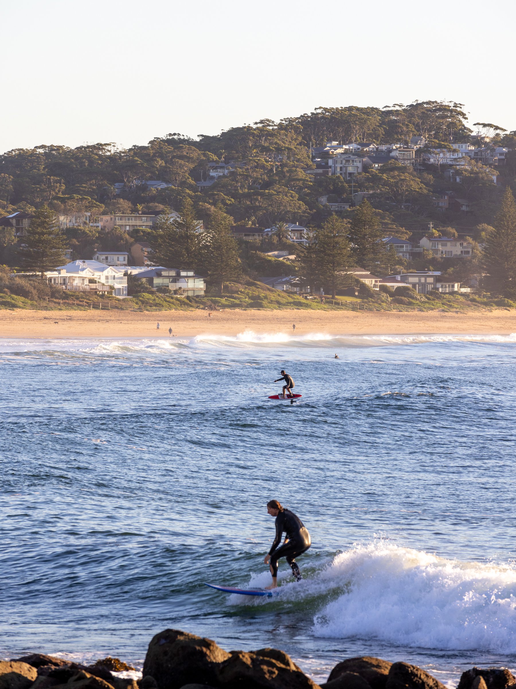 Surfer riding a wave at Avoca Beach on the Central Coast of NSW Australia