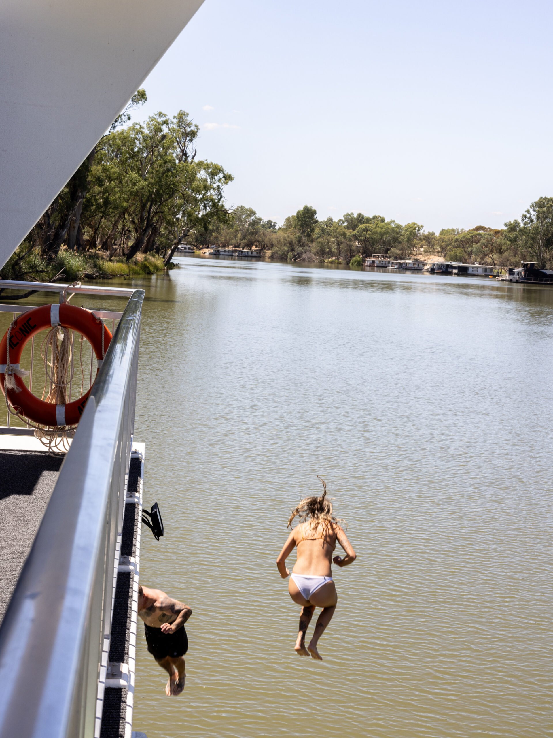 Jumping off the back of the house boat into the water