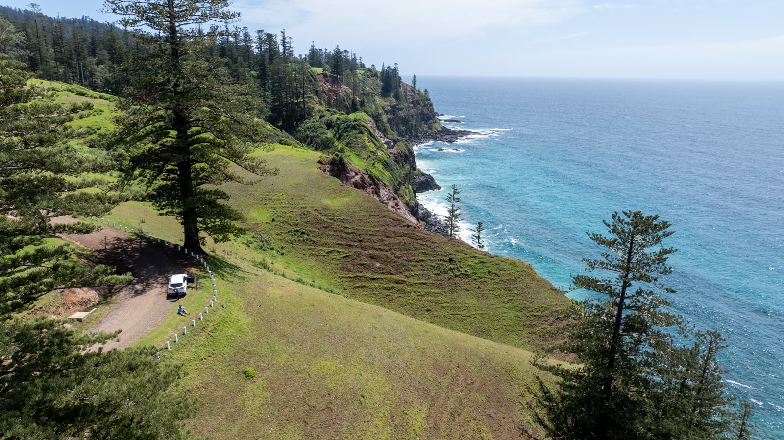 Car parked on side of the road with views over the ocean in Norfolk Island