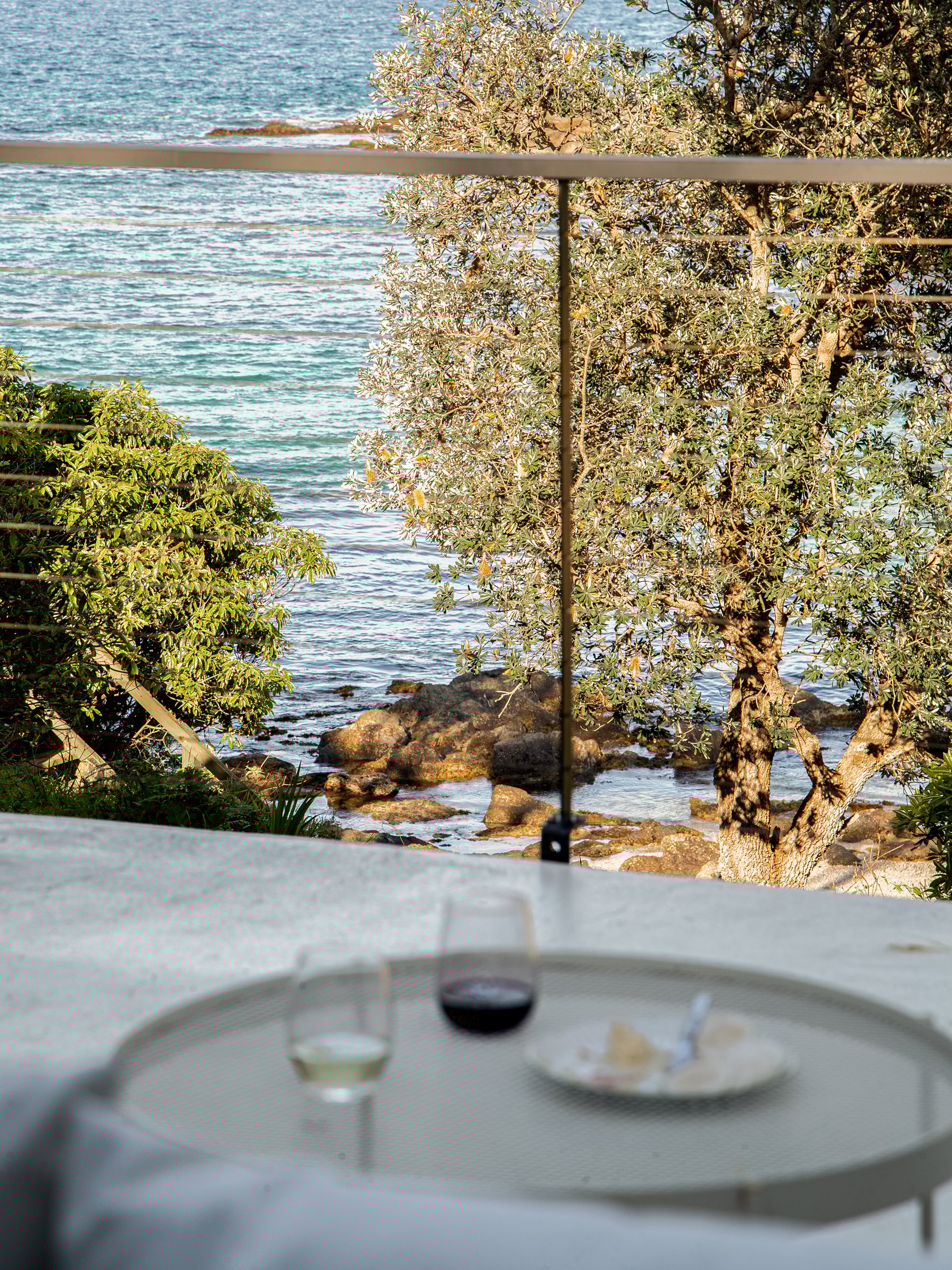 Glass of wine on a balcony over looking the ocean