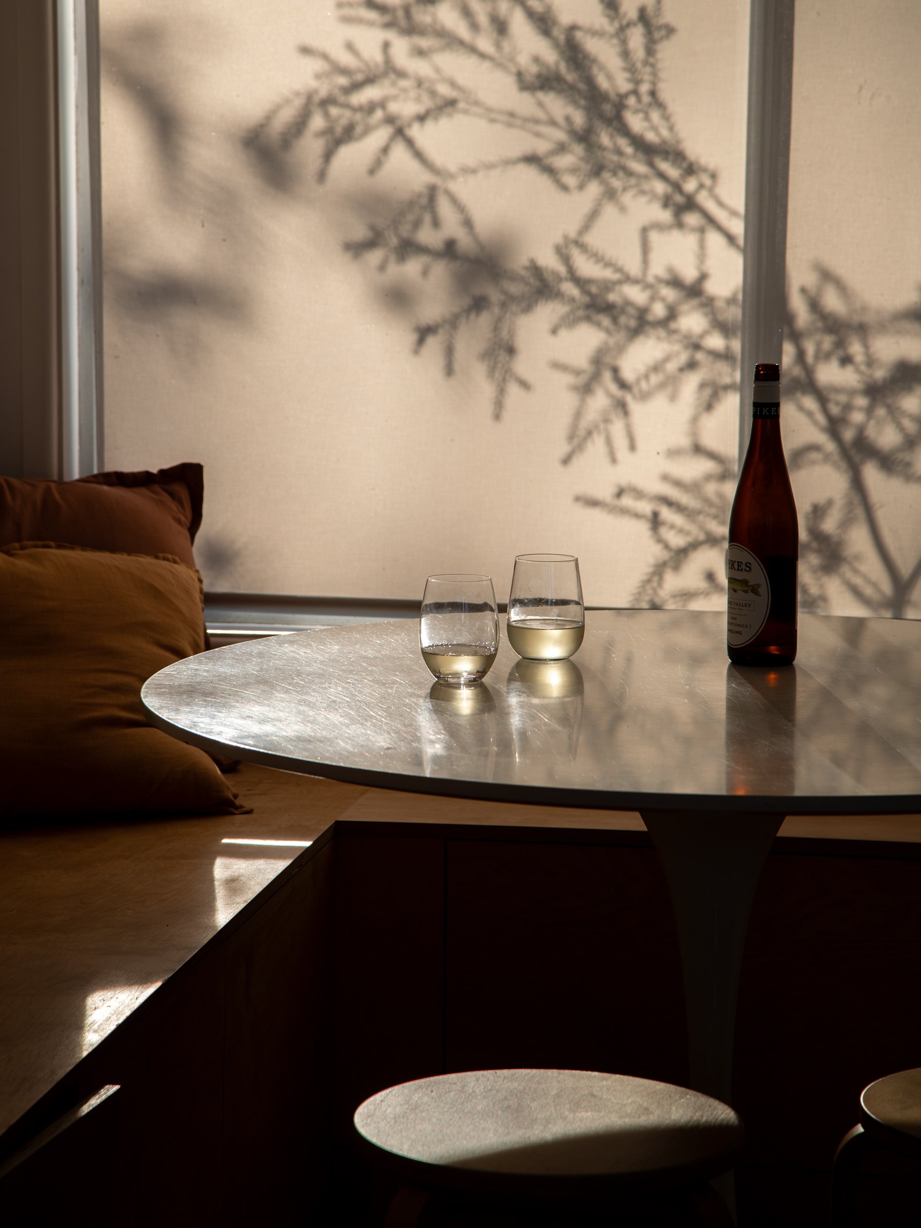 2 Glasses of wine on a round dining table